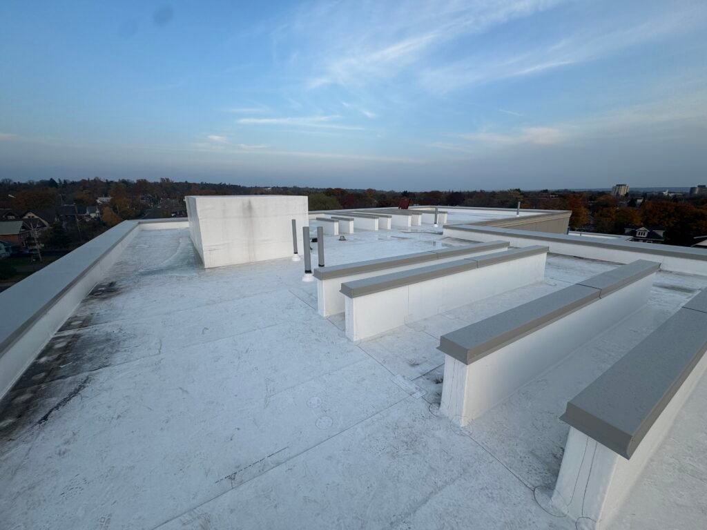 Finished white PVC roof with parapet walls on the residential new build in Sault Ste. Marie, a new construction commercial roofing project by OYH Roofing