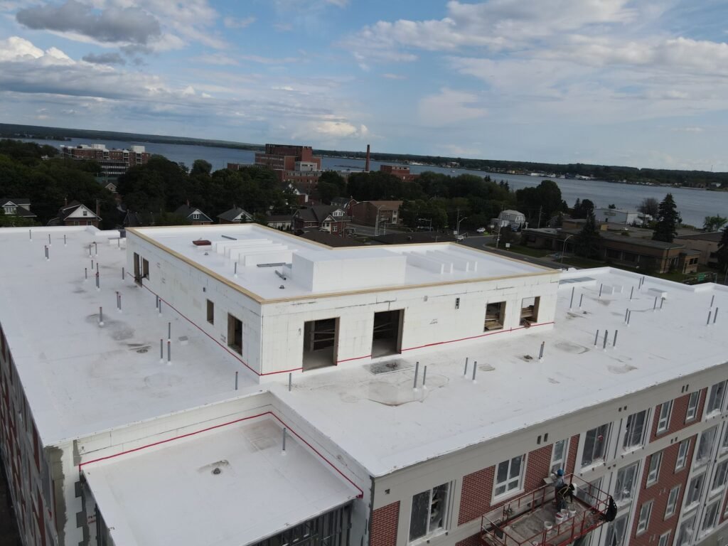 Penthouse and lower roof on the PVC roof of a new residential building in Sault Ste. Marie, the drift areas engineers check in a flat roof snow load design