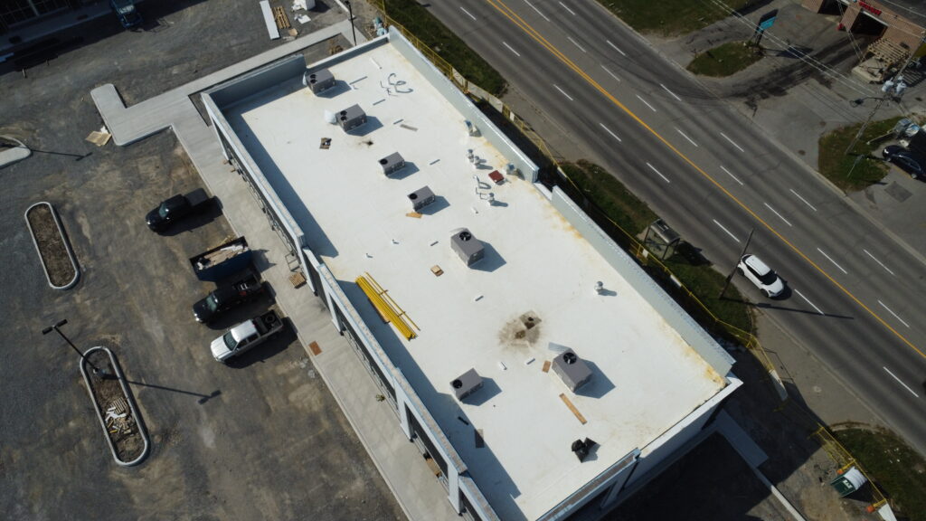 TPO flat roof installation on commercial plaza — OYH Roofing