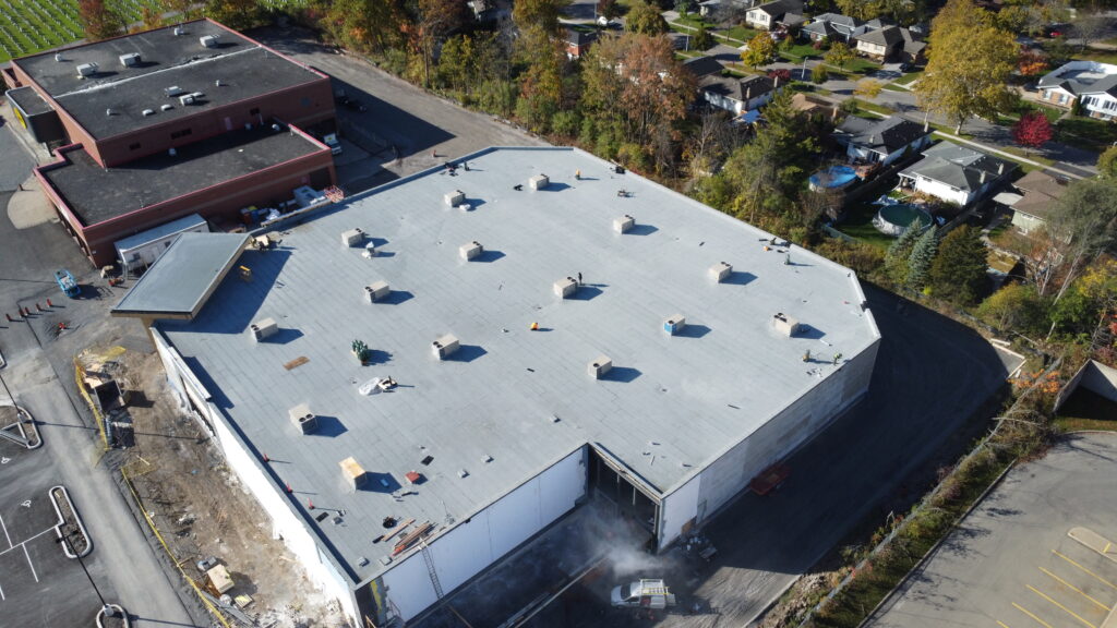 High angle drone shot of modified bitumen roof installation at 777 Niagara St Welland 52300 sqft commercial roof